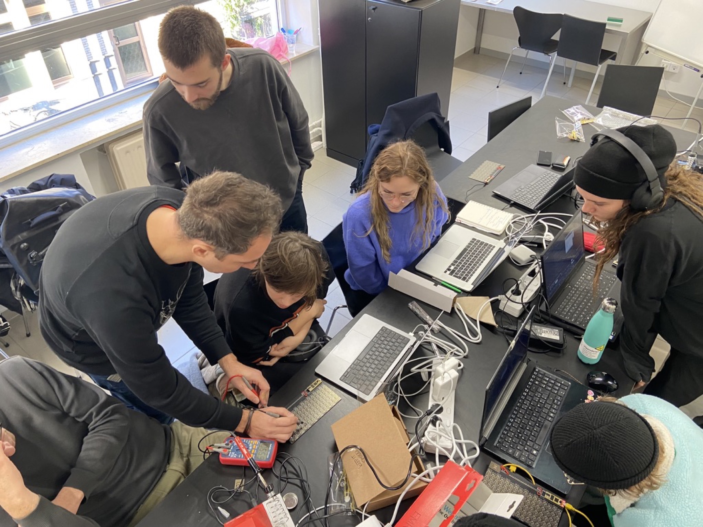 Students and coaches collaborating on electronics at Code Space